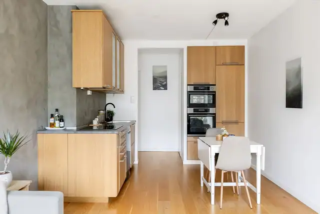 Stilrent kjøkken fra IKEA med finerte eikefronter, benkeplate i tre og oppvaskkum med ettgreps blandebatteri.