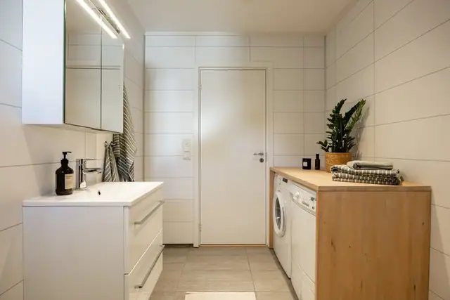 Det er flislagte vegger og gulv, behagelig gulvvarme og downlights i himlingen.